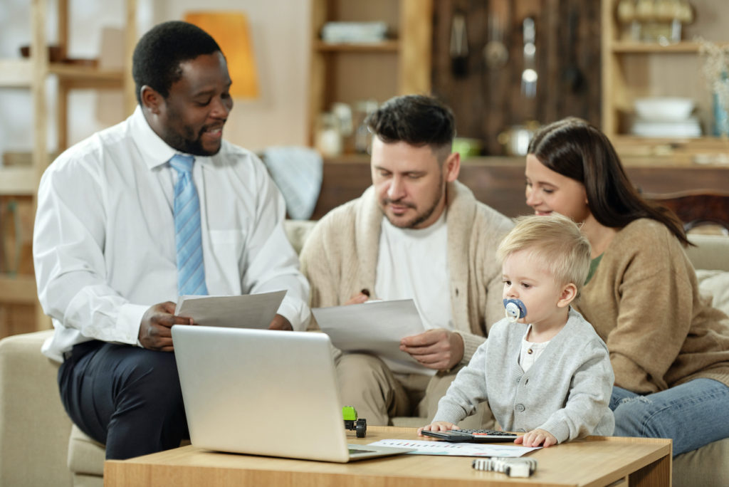 Couple with kid having meeting with adviser