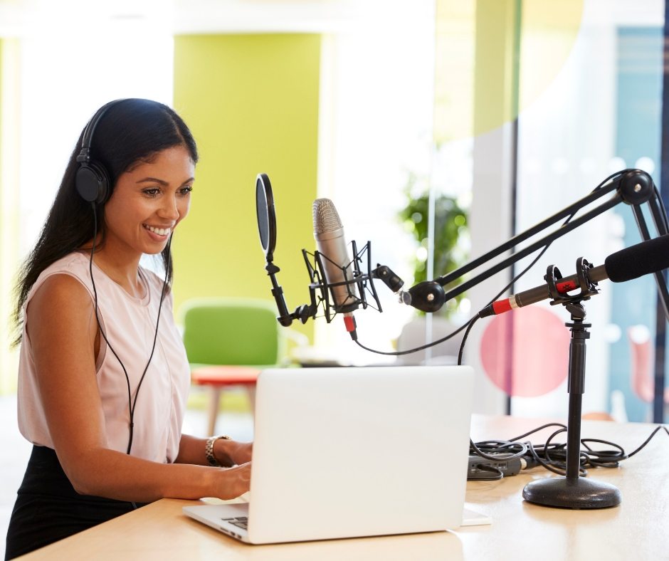 podcast woman with laptop and mic set up
